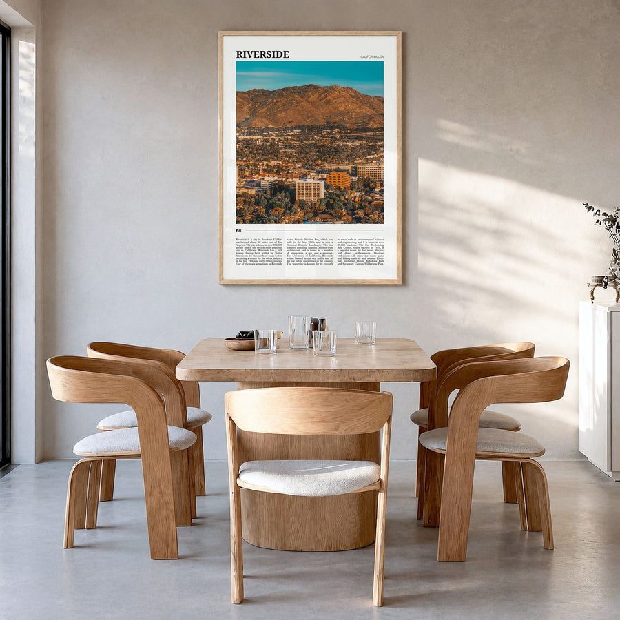 Riverside Travel Poster in a natural wood frame, hanging in a dining room