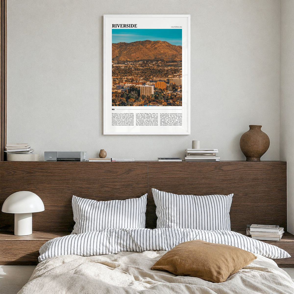 Riverside Travel Poster in a white wood frame, hanging in a bedroom