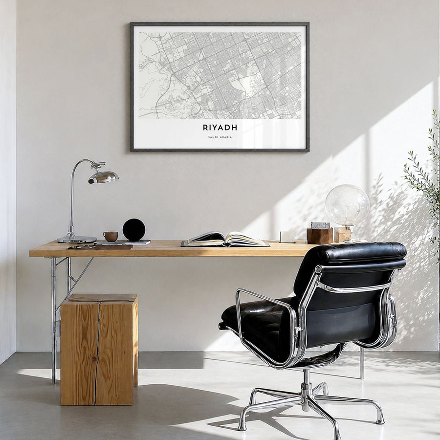 Riyadh Map Poster in a black wood frame, hanging in a bright home office