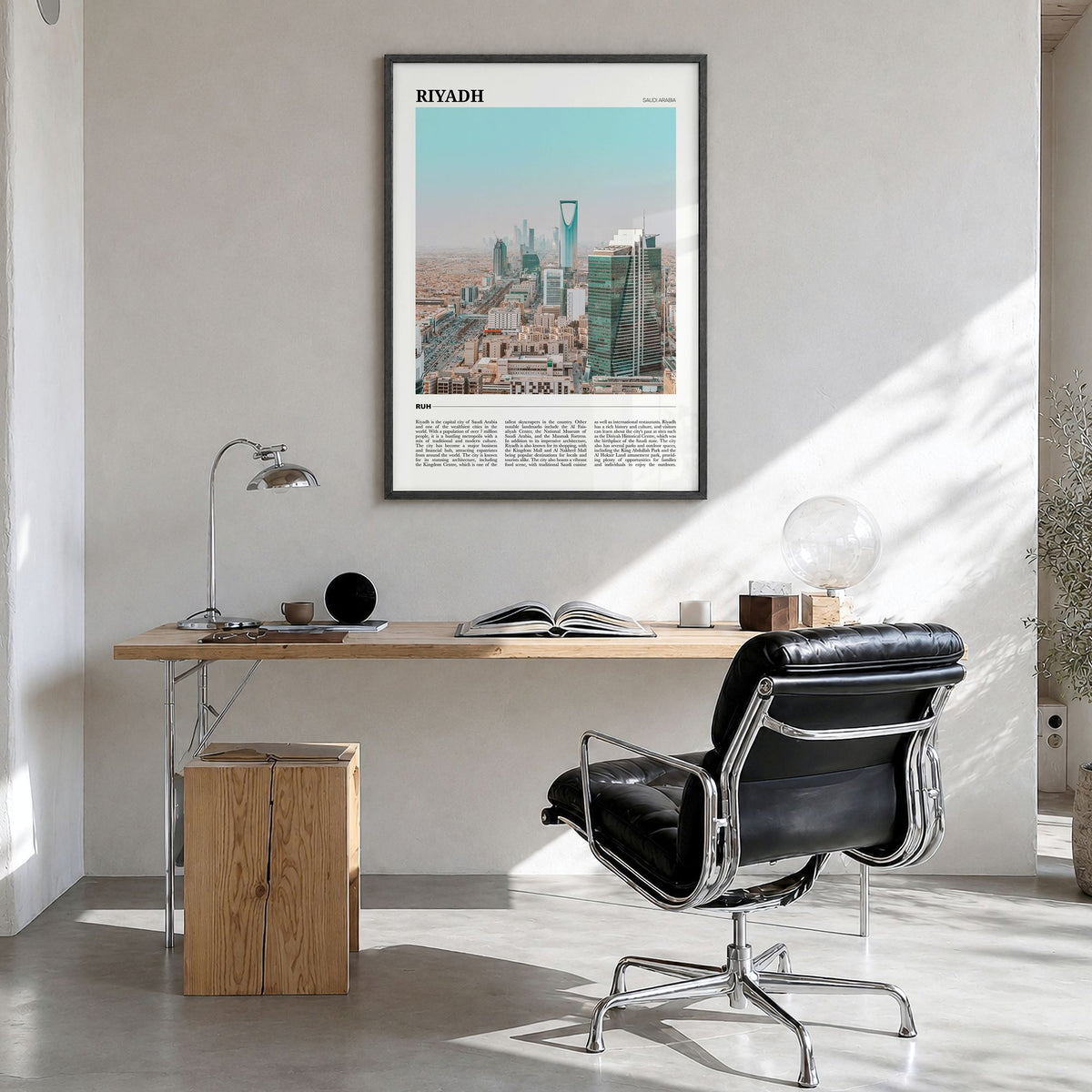 Riyadh Travel Poster in a black wood frame, hanging in a bright home office