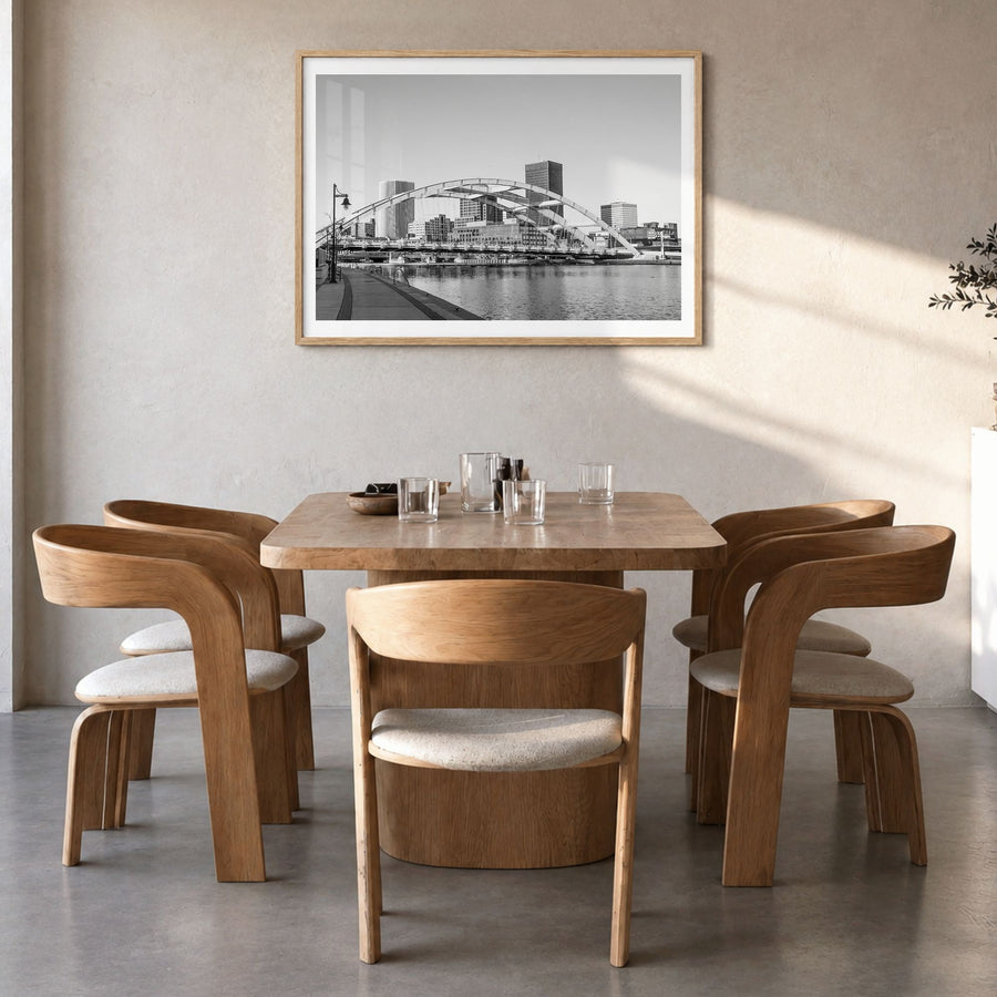 Rochester, New York Photo Poster in a natural wood frame, hanging in a dining room, white border