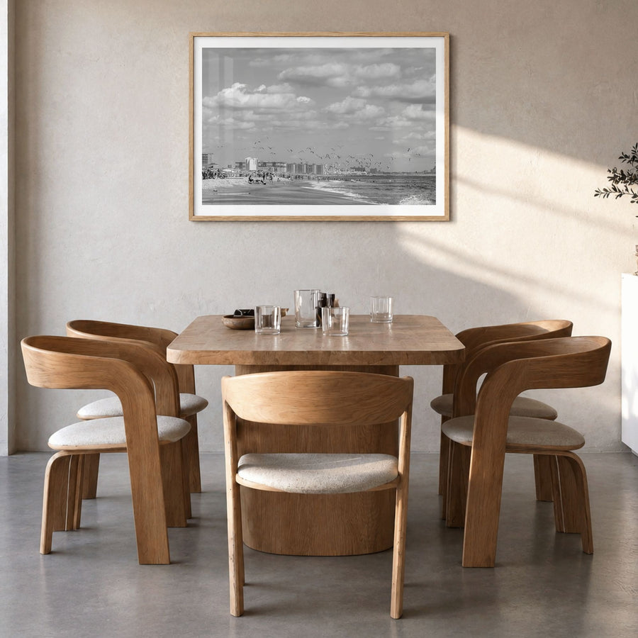 Rockaway Beach Photo Poster in a natural wood frame, hanging in a dining room, white border