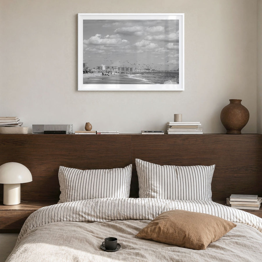 Rockaway Beach Photo Poster in a white wood frame, hanging in a bedroom, white border