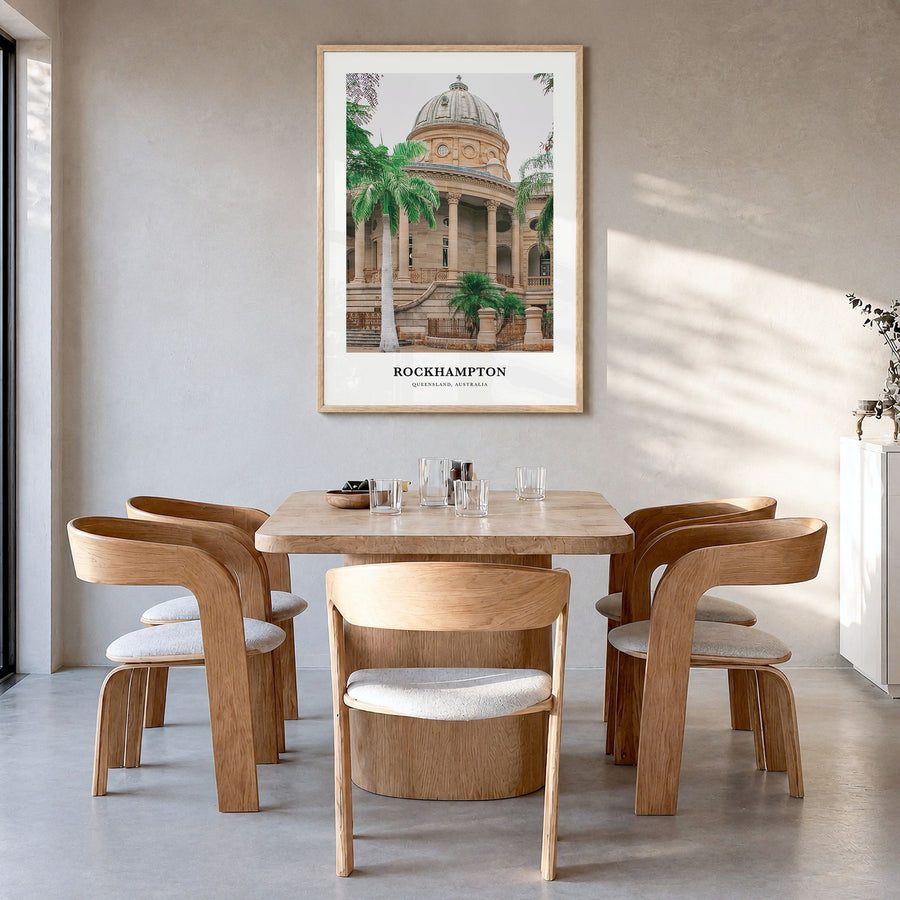 Rockhampton Classic Poster in a natural wood frame, hanging in a dining room
