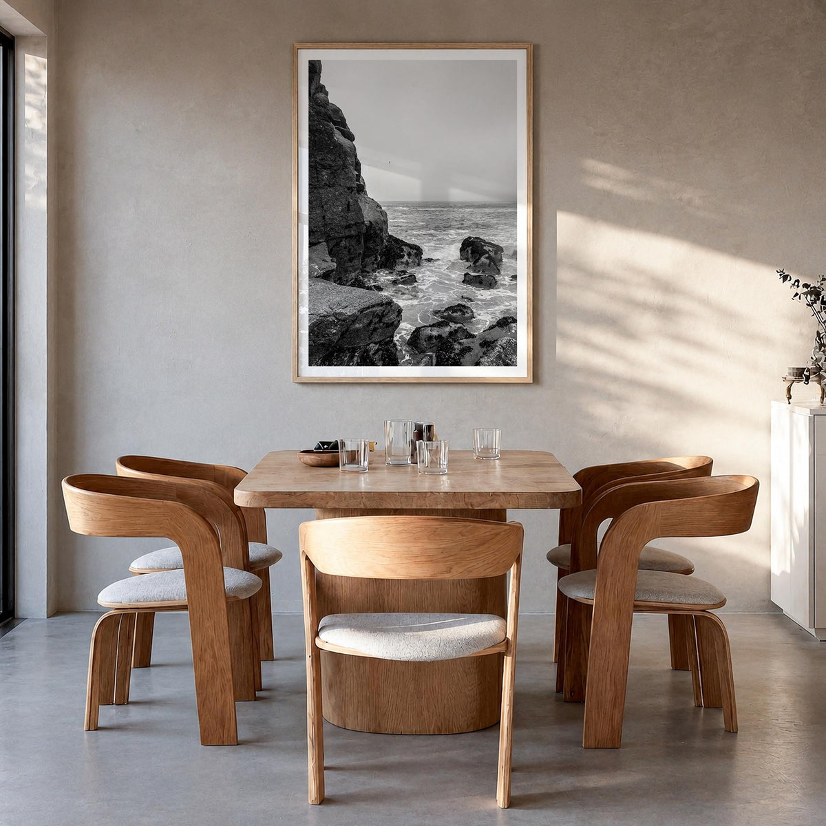Rocky Coast no. 2 black & white photo poster – vertical wall art in natural wood frame with white border, hanging on wall