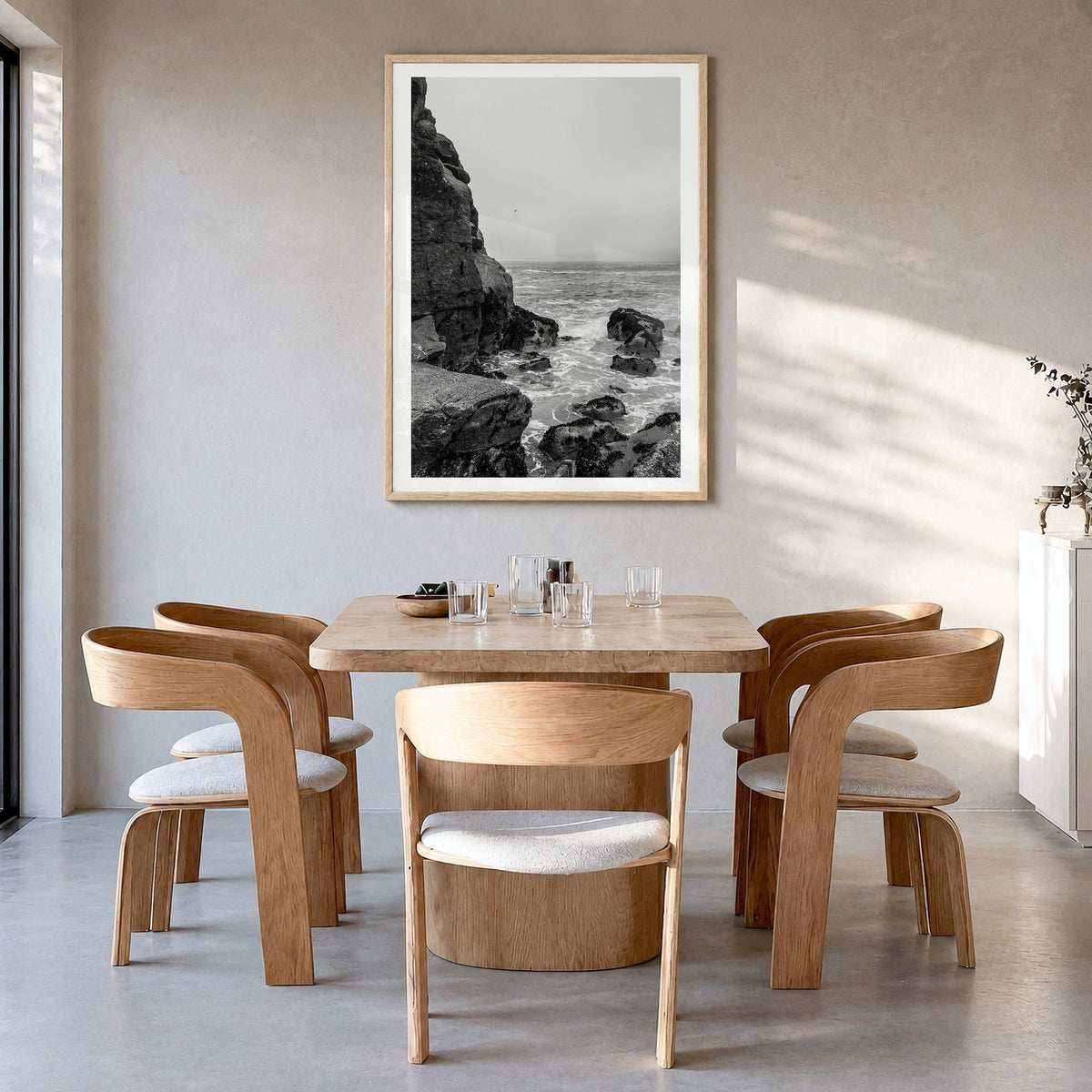 Rocky Coast Photo No 2 Poster in a natural wood frame, hanging in a dining room, white border