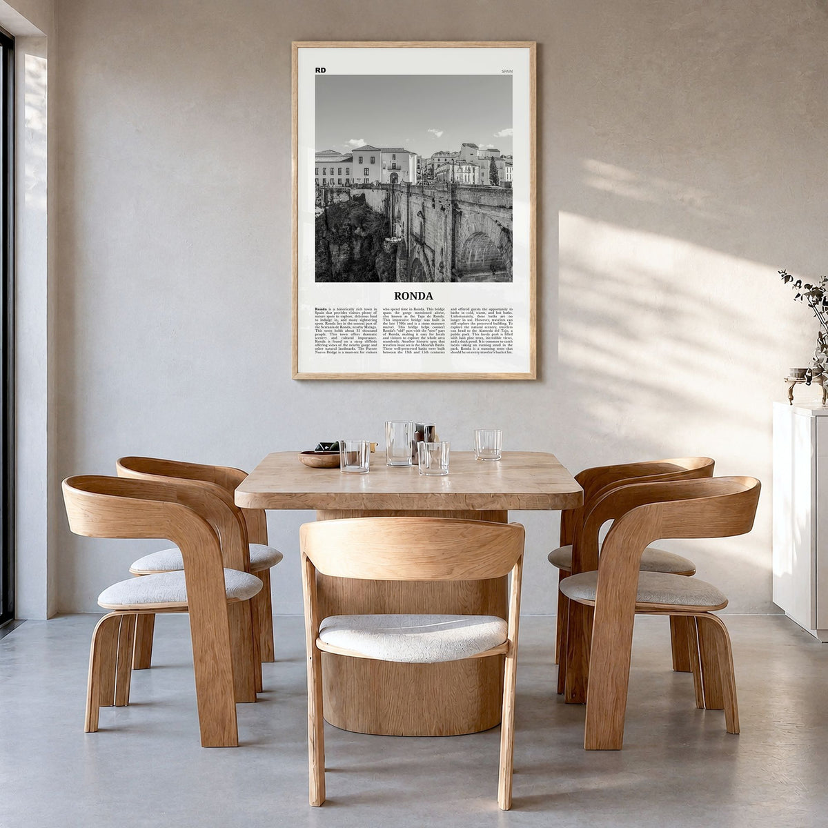 Ronda Newspaper Poster in a natural wood frame, hanging in a dining room