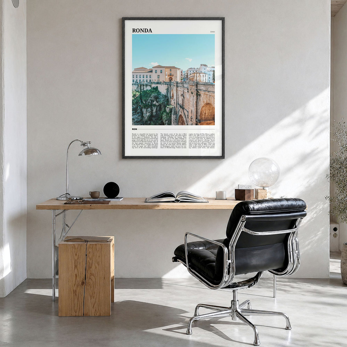 Ronda Travel Poster in a black wood frame, hanging in a bright home office