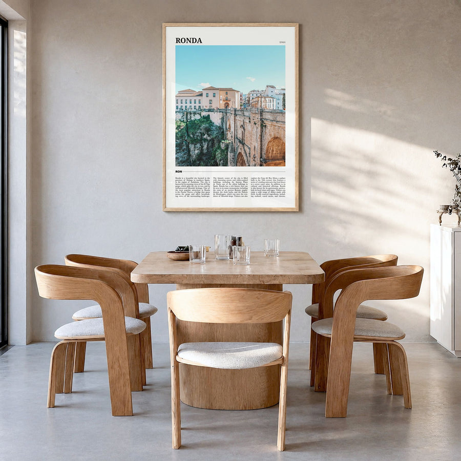 Ronda Travel Poster in a natural wood frame, hanging in a dining room