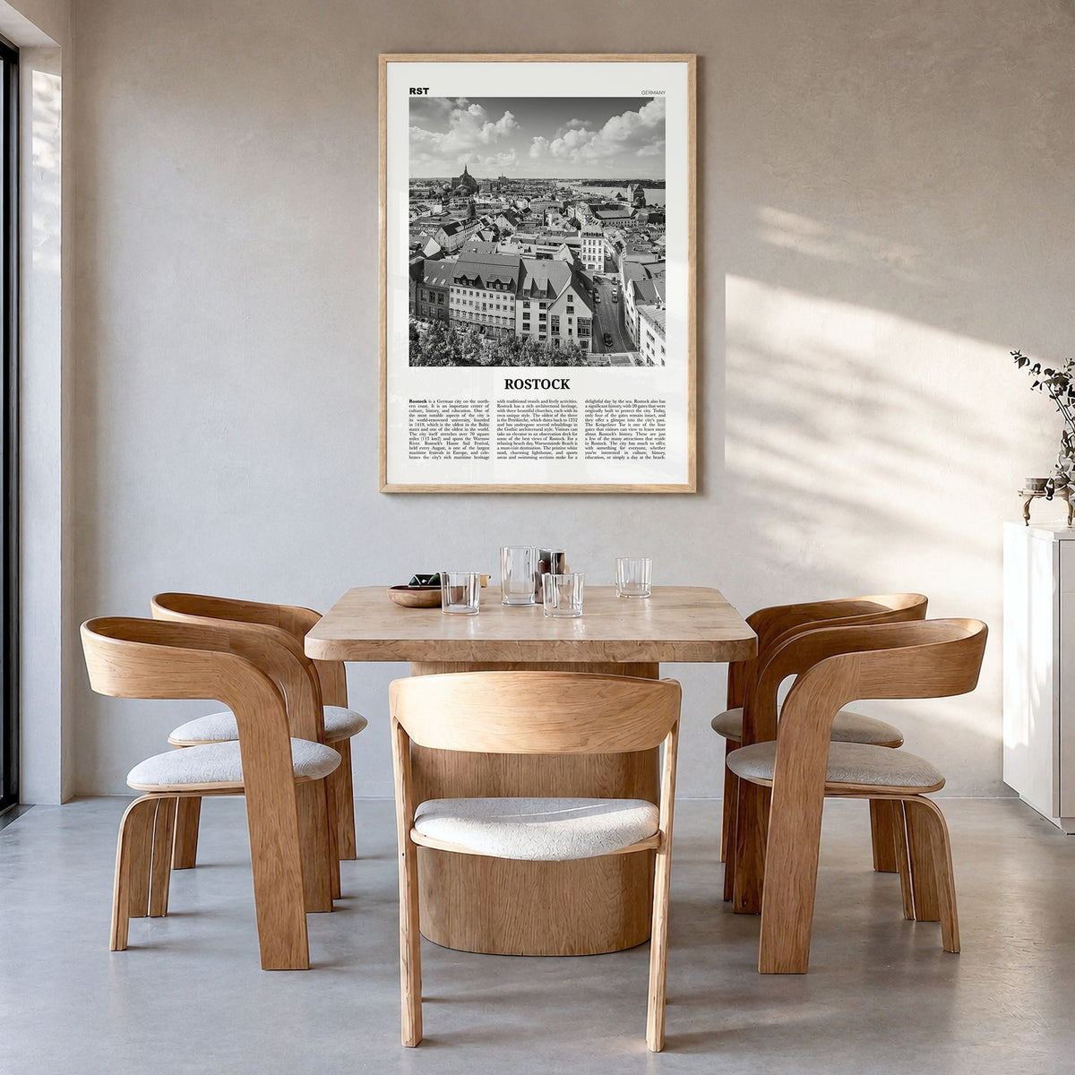 Rostock Newspaper Poster in a natural wood frame, hanging in a dining room
