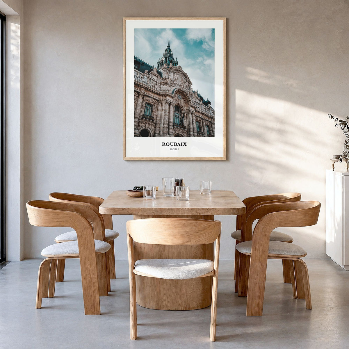 Roubaix Classic Poster in a natural wood frame, hanging in a dining room