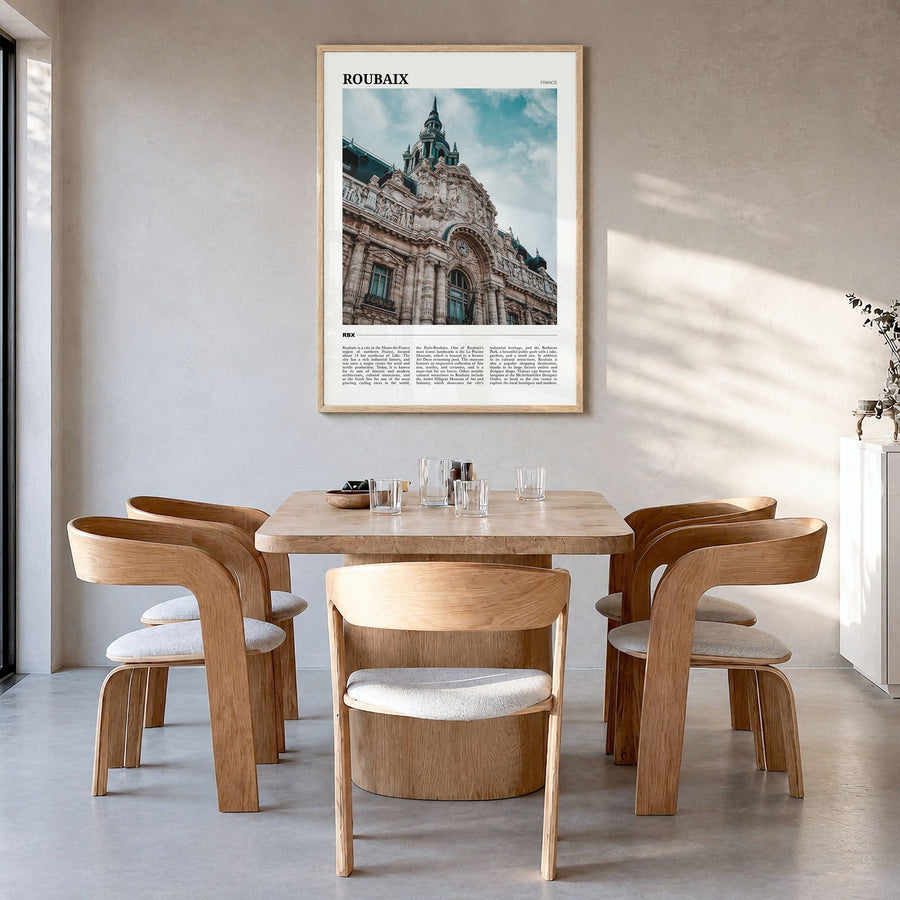 Roubaix Travel Poster in a natural wood frame, hanging in a dining room