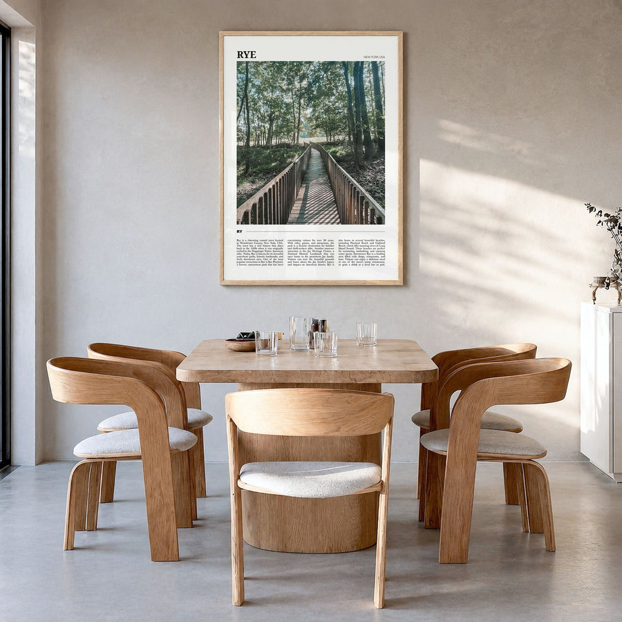 Rye Travel Poster in a natural wood frame, hanging in a dining room