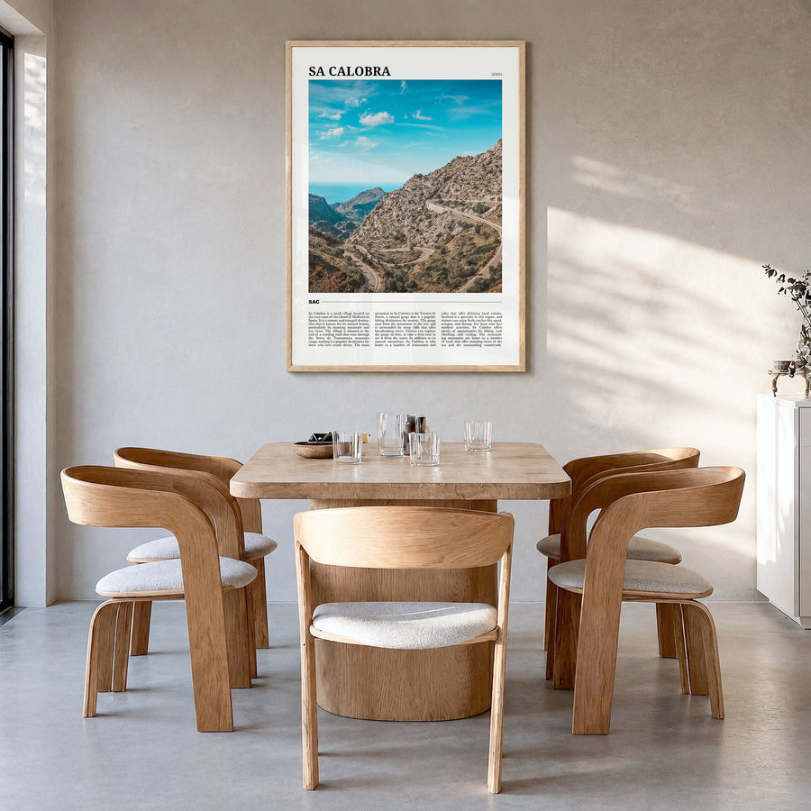 Sa Calobra Travel Poster in a natural wood frame, hanging in a dining room