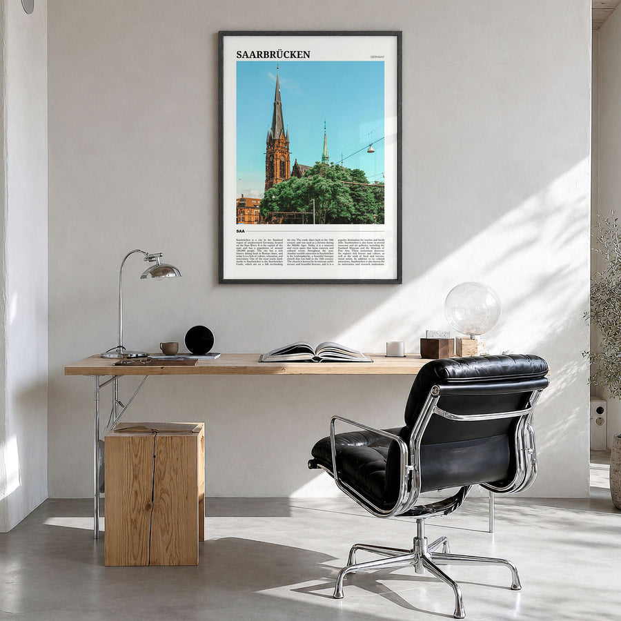 Saarbrücken Travel Poster in a black wood frame, hanging in a bright home office