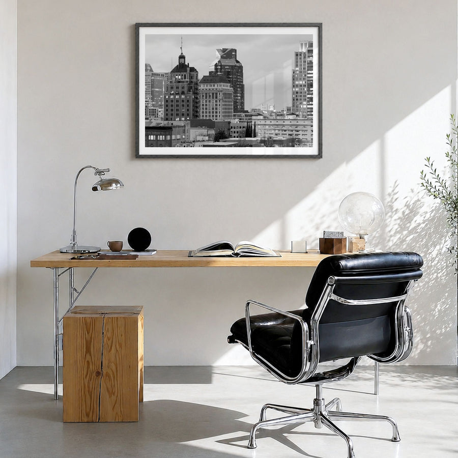 Sacramento Photo Poster in a black wood frame, hanging in a bright home office, white border