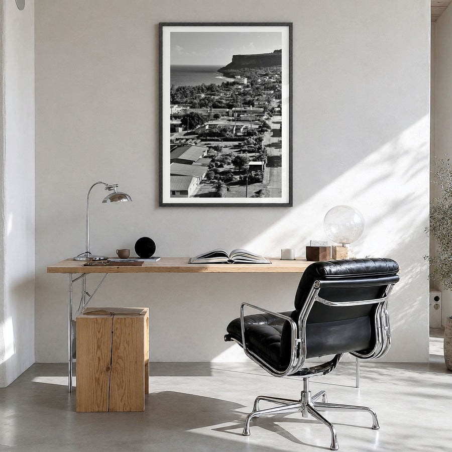 Saipan Photo Poster in a black wood frame, hanging in a bright home office, white border