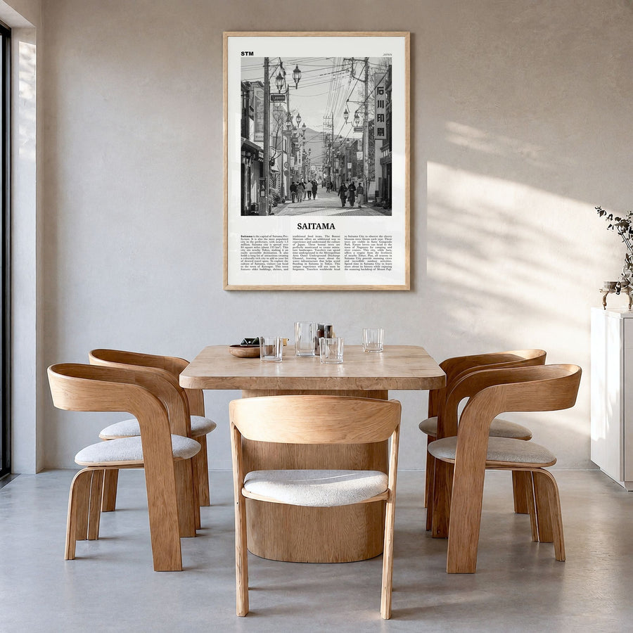 Saitama Newspaper Poster in a natural wood frame, hanging in a dining room
