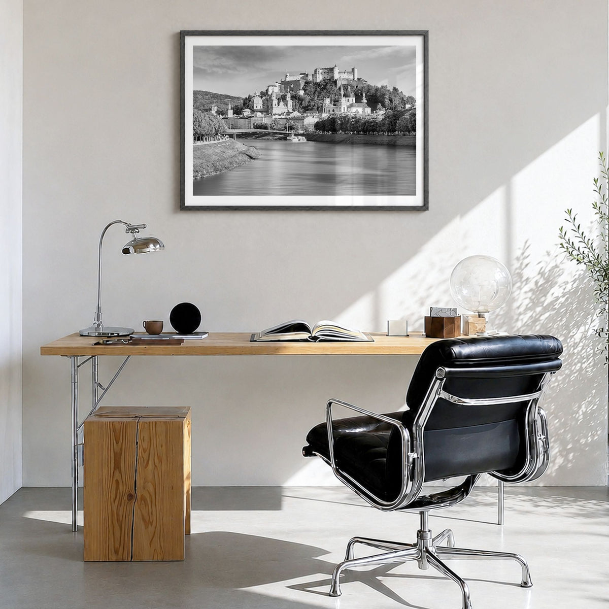 Salzburg Photo Poster in a black wood frame, hanging in a bright home office, white border