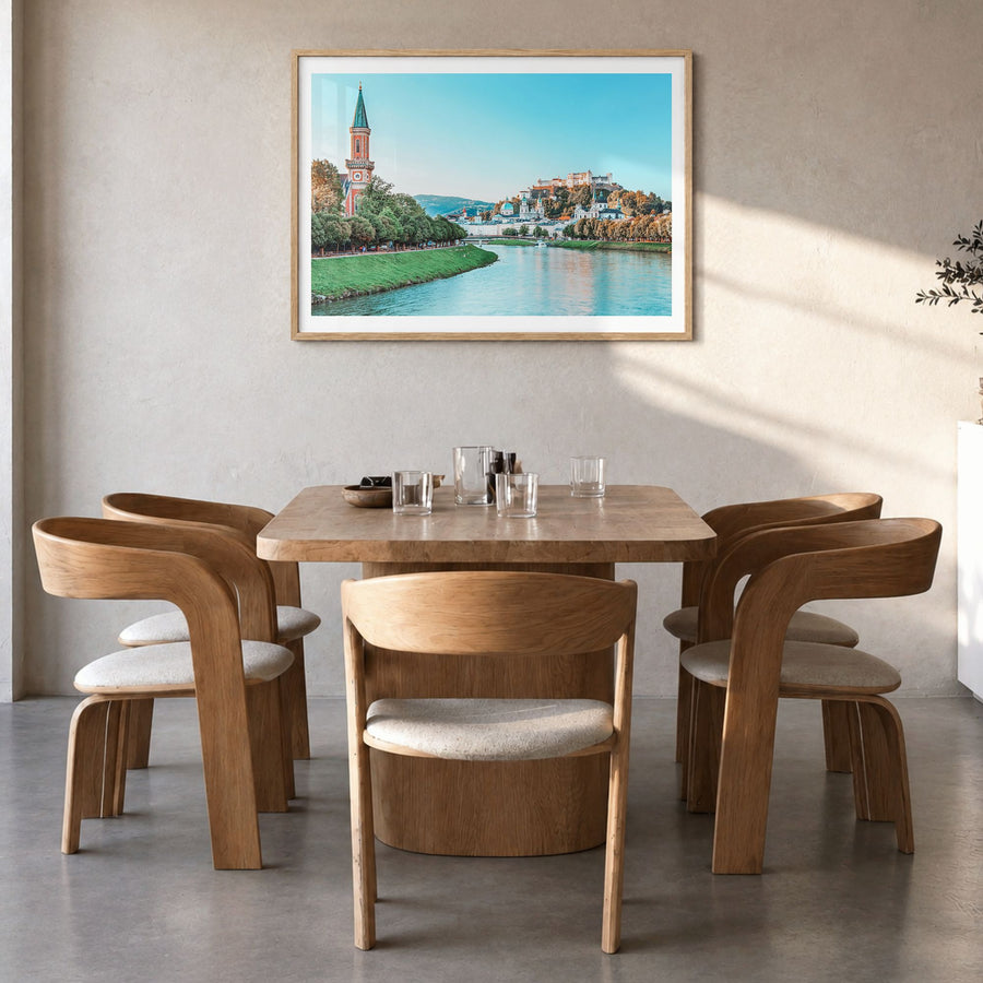 Salzburg Photo Poster in a natural wood frame, hanging in a dining room, white border