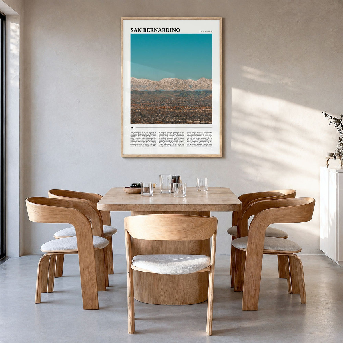 San Bernardino Travel Poster in a natural wood frame, hanging in a dining room