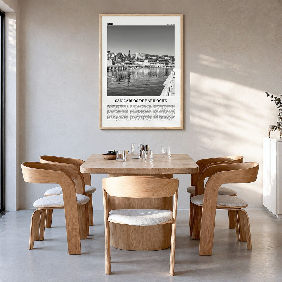 San Carlos de Bariloche Newspaper Poster in a natural wood frame, hanging in a dining room