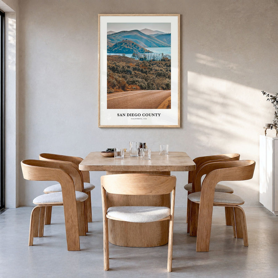 San Diego County Classic Poster in a natural wood frame, hanging in a dining room