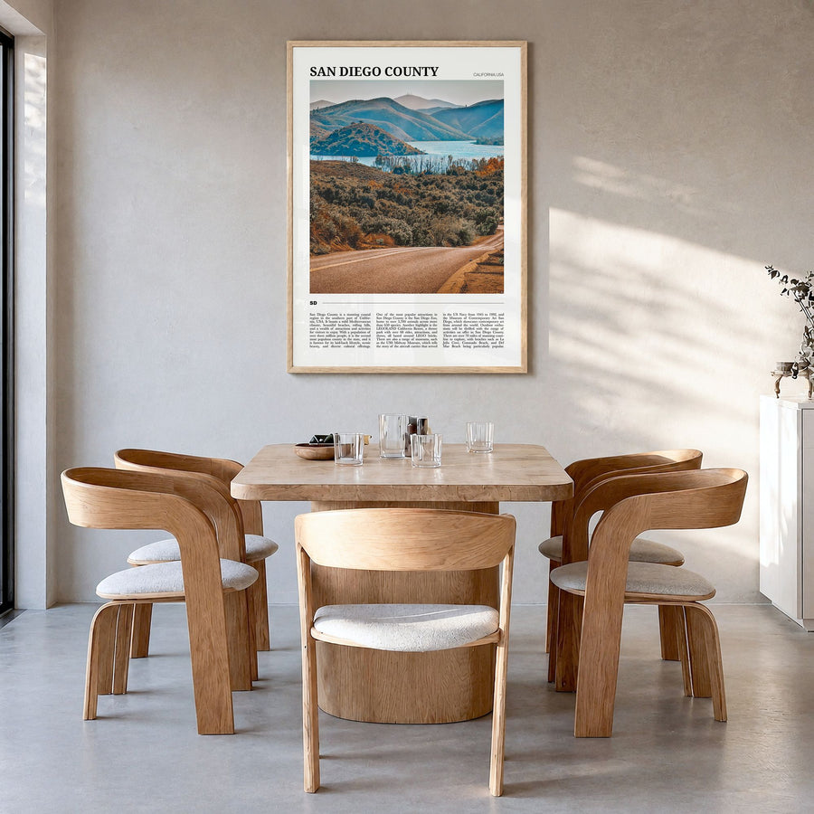 San Diego County Travel Poster in a natural wood frame, hanging in a dining room