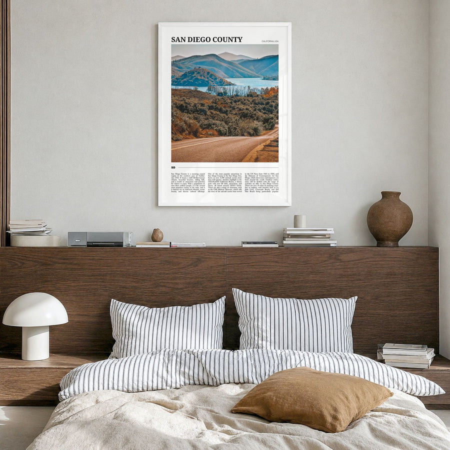 San Diego County Travel Poster in a white wood frame, hanging in a bedroom