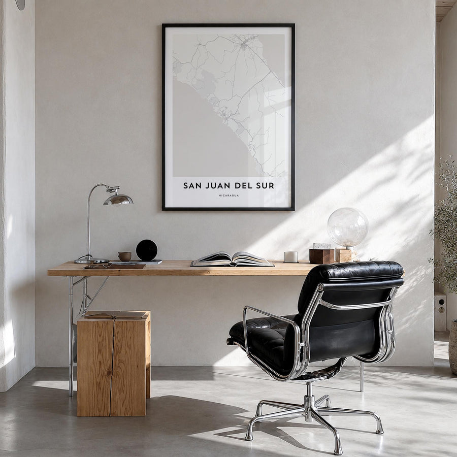San Juan del Sur black & white map poster of Nicaragua – vertical wall art in black wood frame, hanging on wall