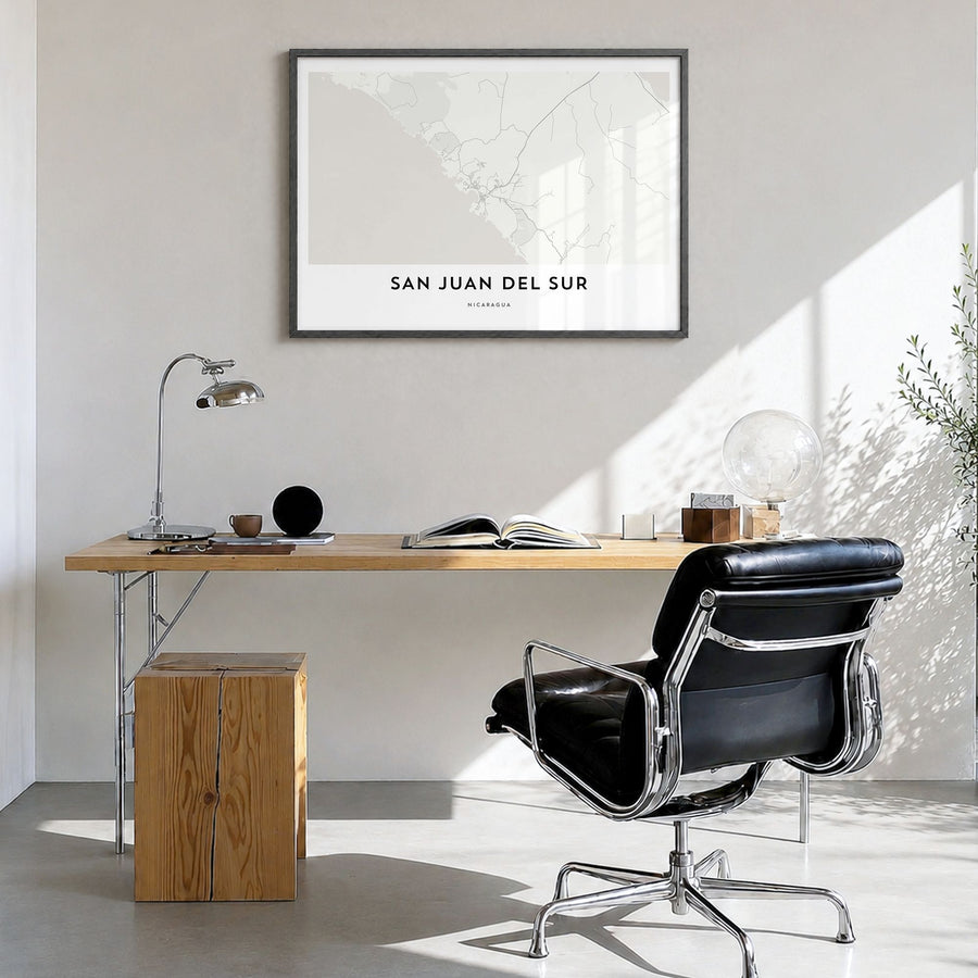 San Juan del Sur Map Poster in a black wood frame, hanging in a bright home office