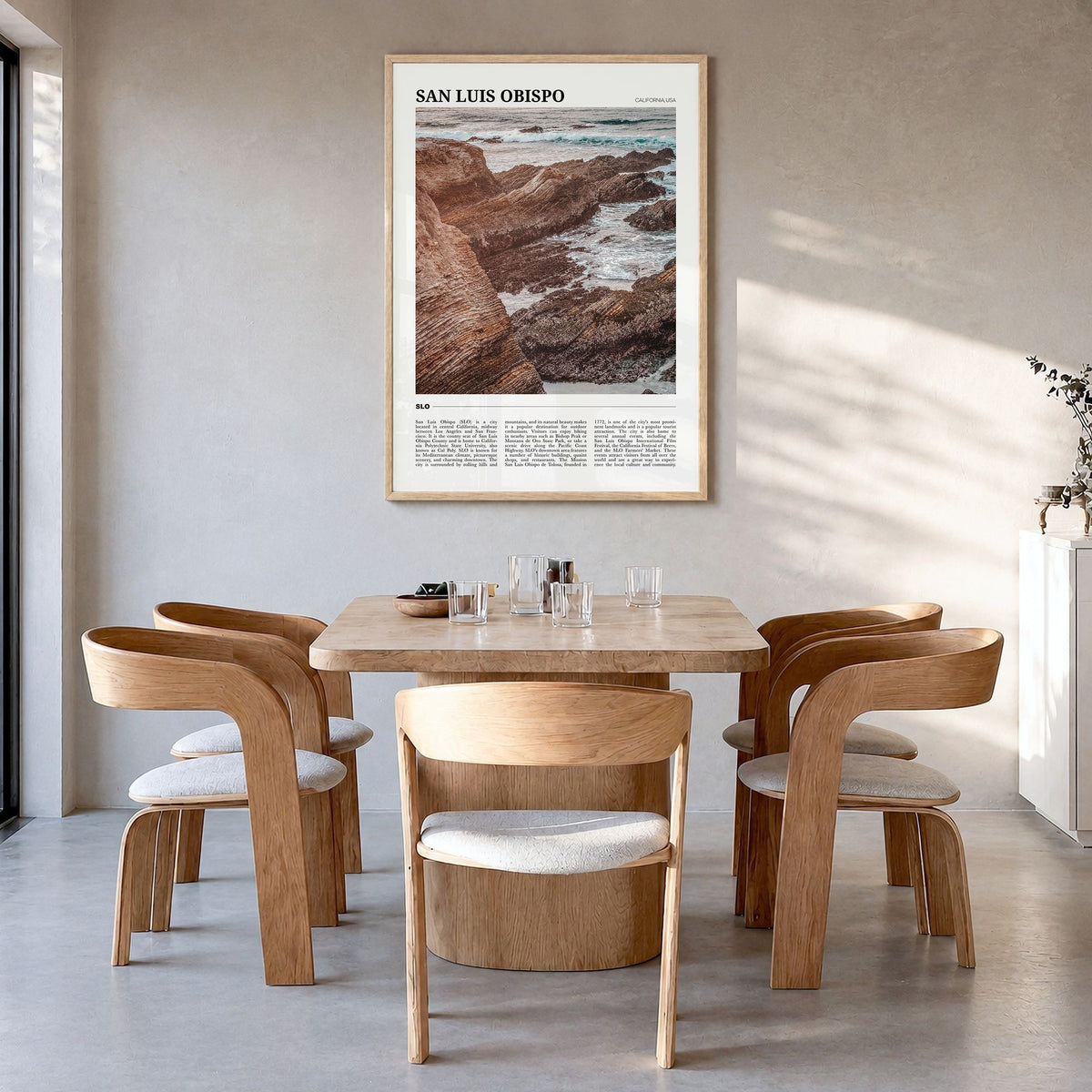 San Luis Obispo Travel No 1 Poster in a natural wood frame, hanging in a dining room
