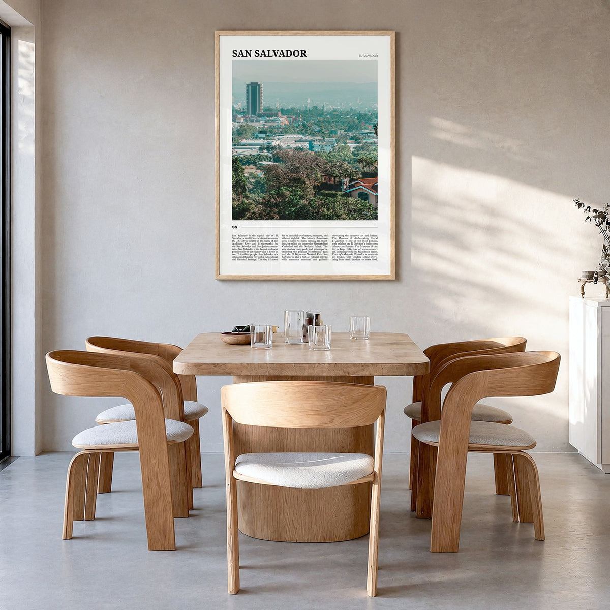 San Salvador Travel Poster in a natural wood frame, hanging in a dining room