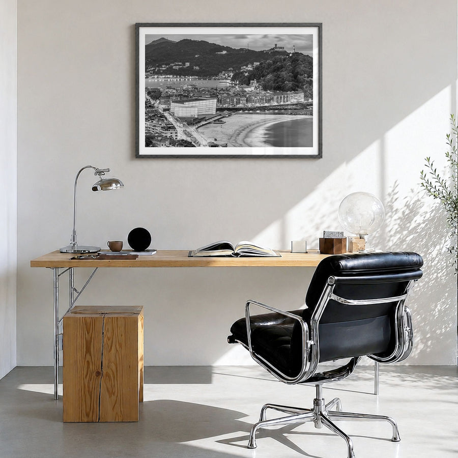 San Sebastián Photo Poster in a black wood frame, hanging in a bright home office, white border