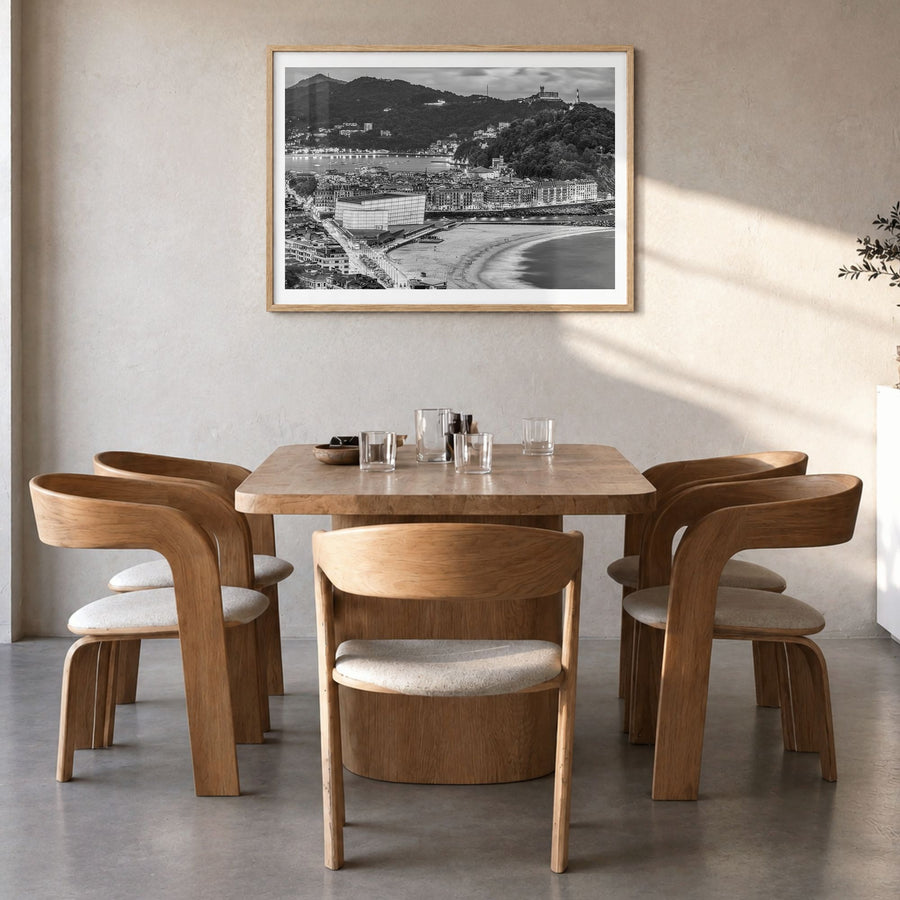 San Sebastián Photo Poster in a natural wood frame, hanging in a dining room, white border