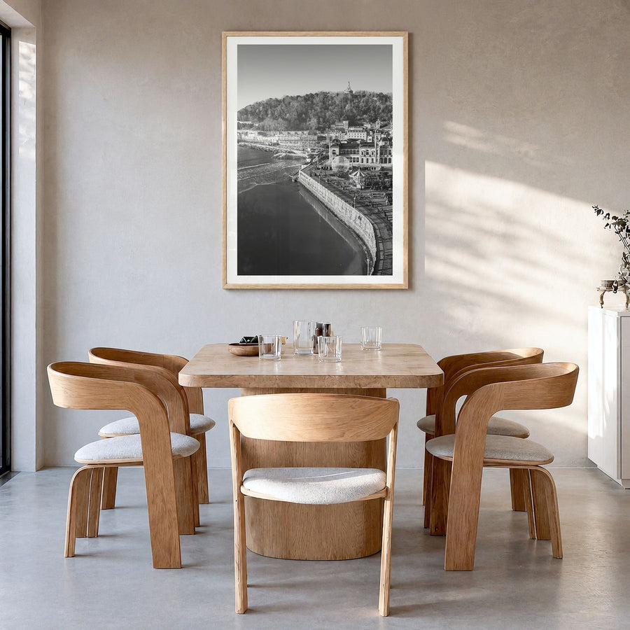 San Sebastián Photo Poster in a natural wood frame, hanging in a dining room, white border