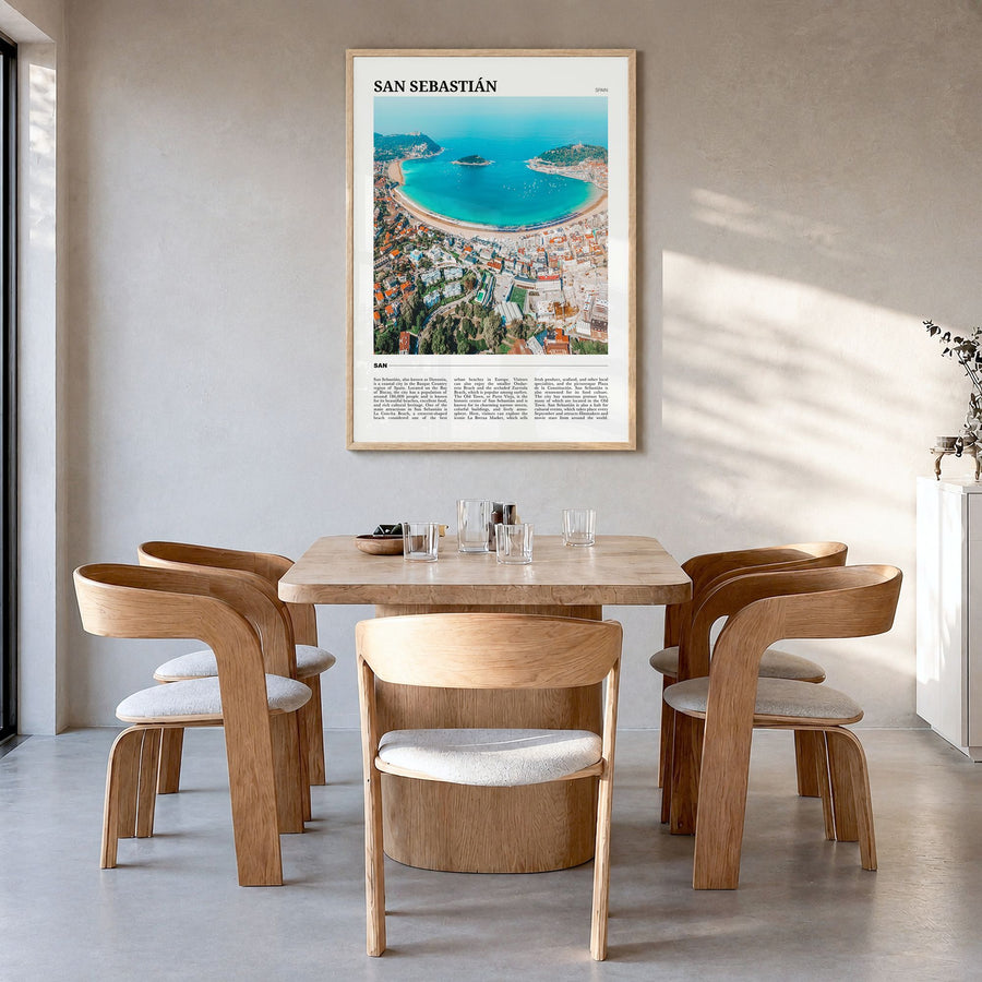 San Sebastián Travel Poster in a natural wood frame, hanging in a dining room