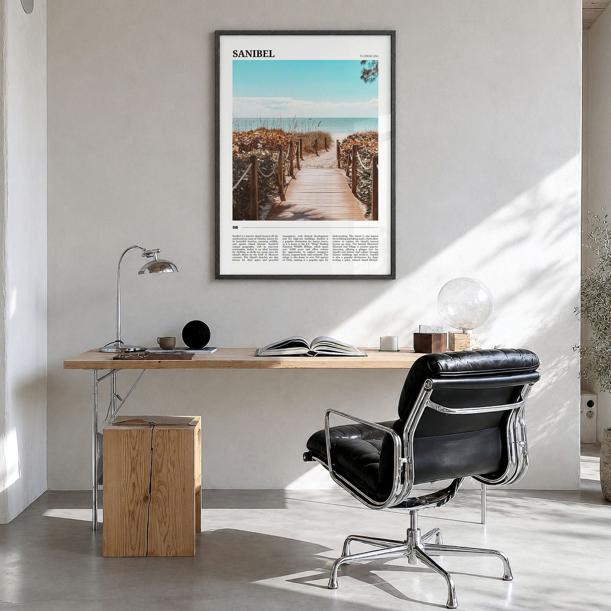Sanibel Travel Poster in a black wood frame, hanging in a bright home office