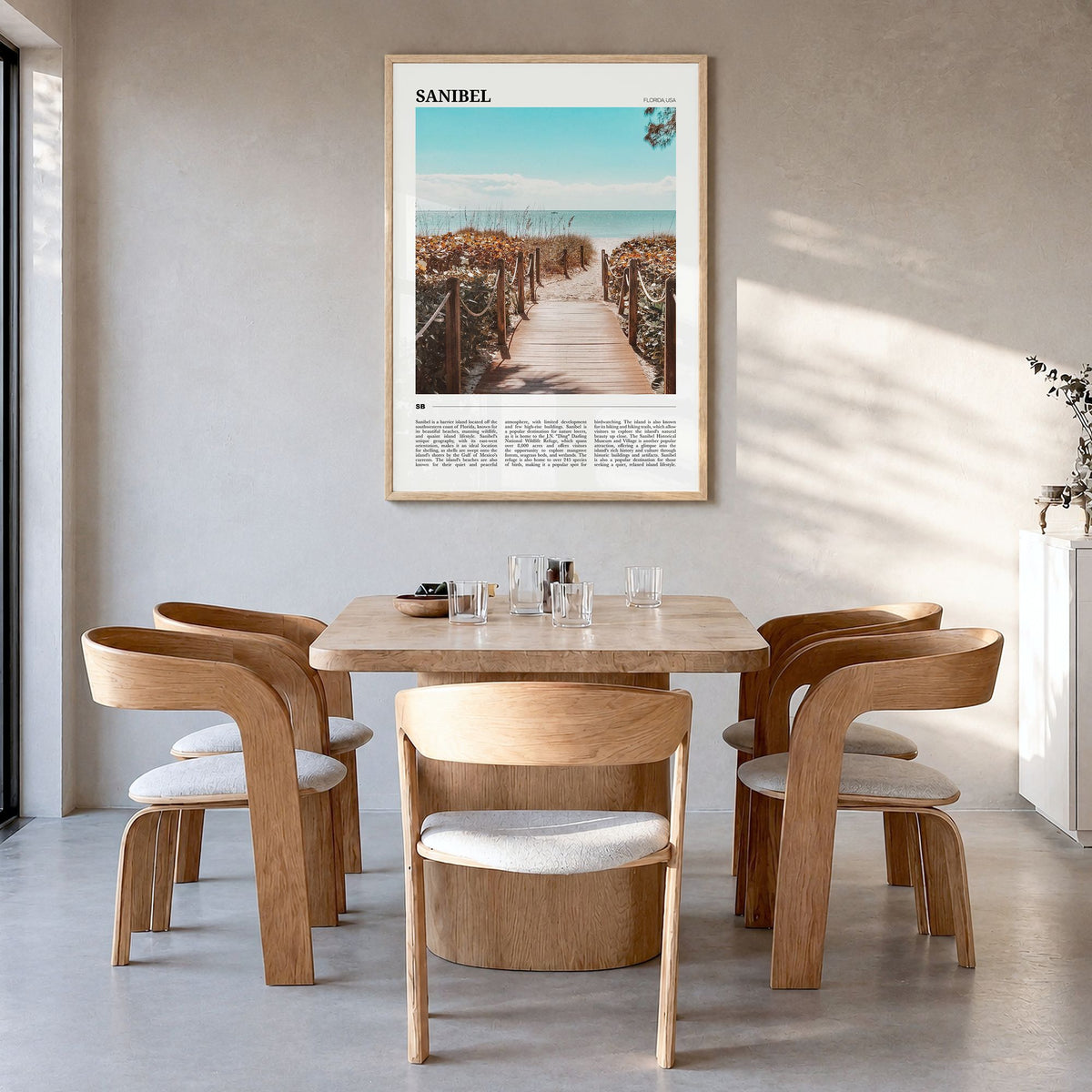 Sanibel Travel Poster in a natural wood frame, hanging in a dining room