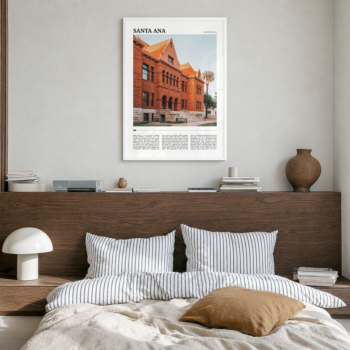 Santa Ana Travel Poster in a white wood frame, hanging in a bedroom