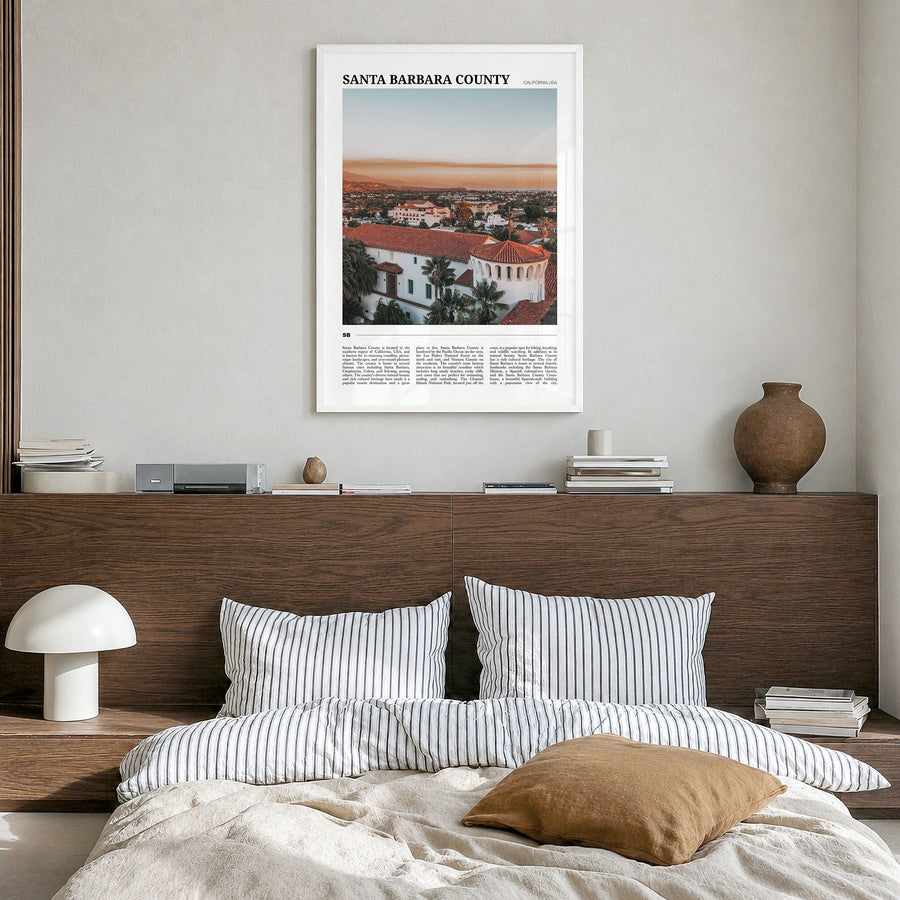Santa Barbara County Travel Poster in a white wood frame, hanging in a bedroom