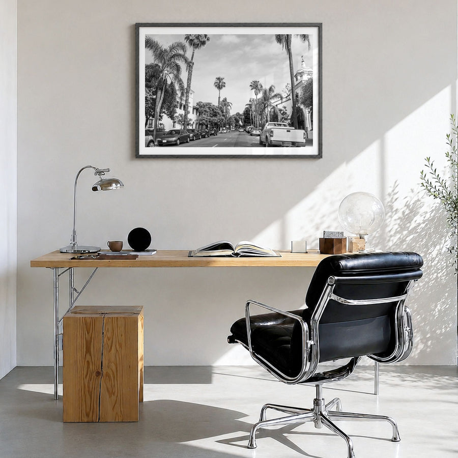 Santa Barbara Photo Poster in a black wood frame, hanging in a bright home office, white border