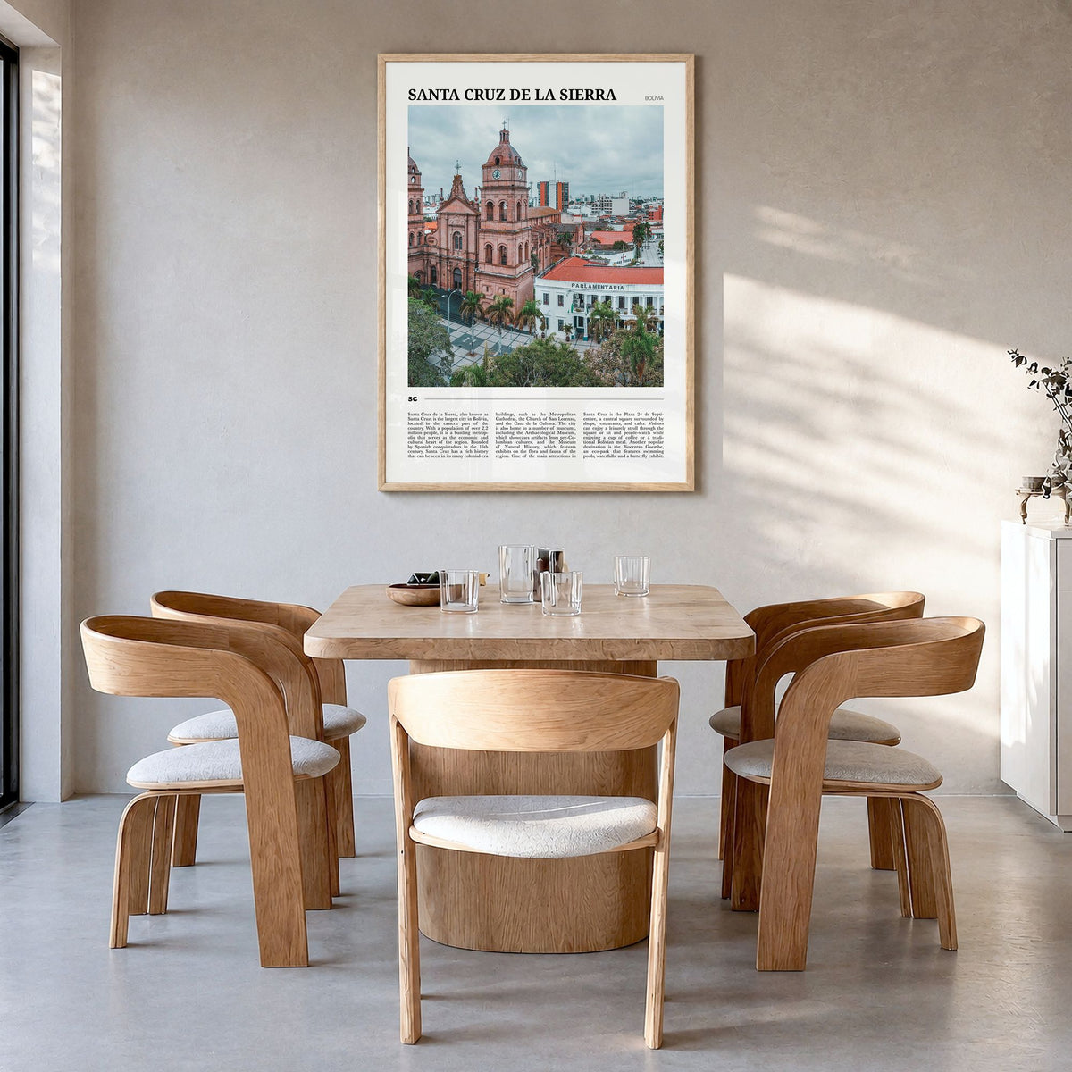 Santa Cruz de la Sierra Travel Poster in a natural wood frame, hanging in a dining room