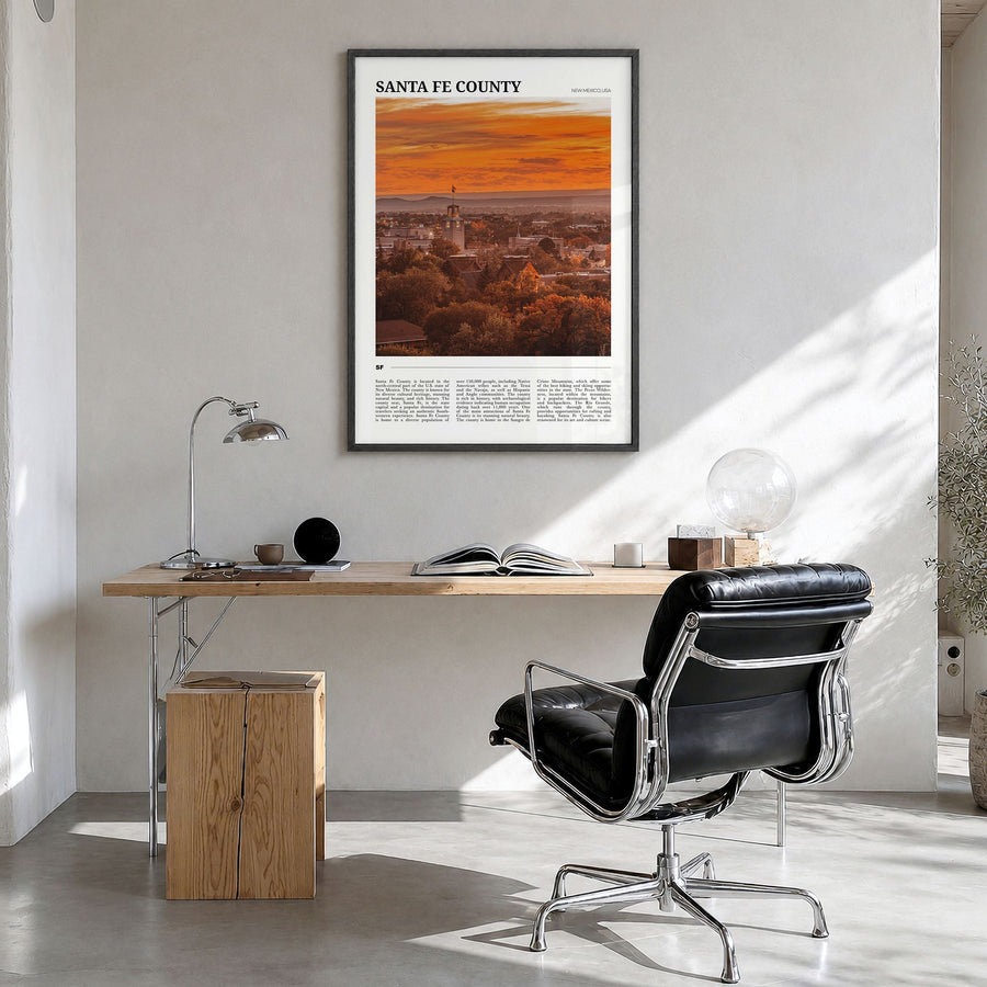 Santa Fe County Travel Poster in a black wood frame, hanging in a bright home office