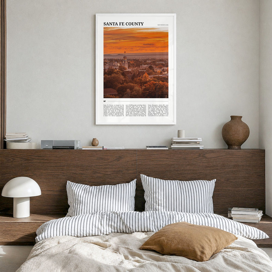 Santa Fe County Travel Poster in a white wood frame, hanging in a bedroom
