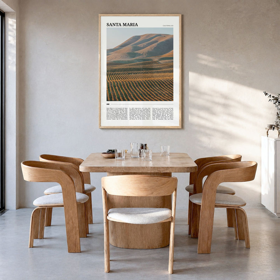 Santa Maria Travel Poster in a natural wood frame, hanging in a dining room