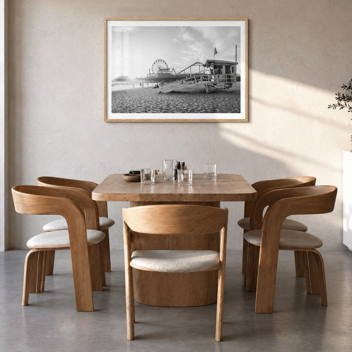 Santa Monica Photo Poster in a natural wood frame, hanging in a dining room, white border