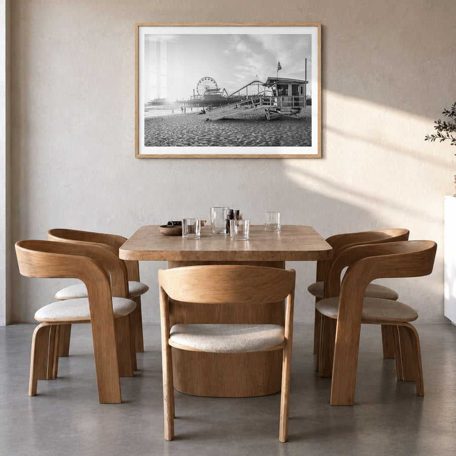 Santa Monica Photo Poster in a natural wood frame, hanging in a dining room, white border