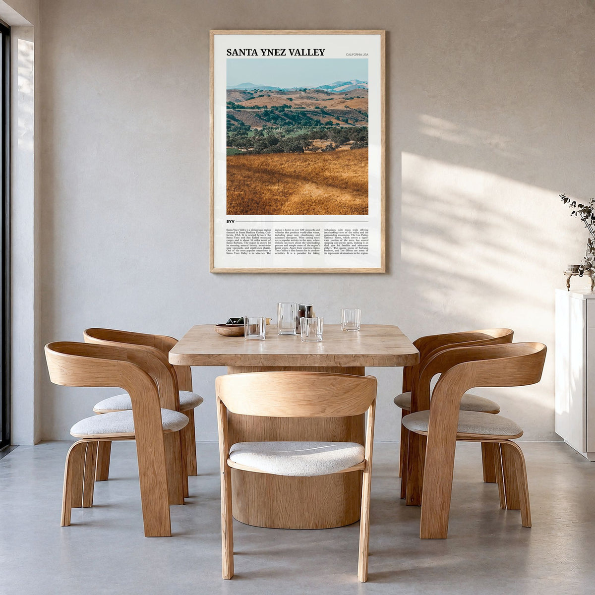 Santa Ynez Valley Travel Poster in a natural wood frame, hanging in a dining room