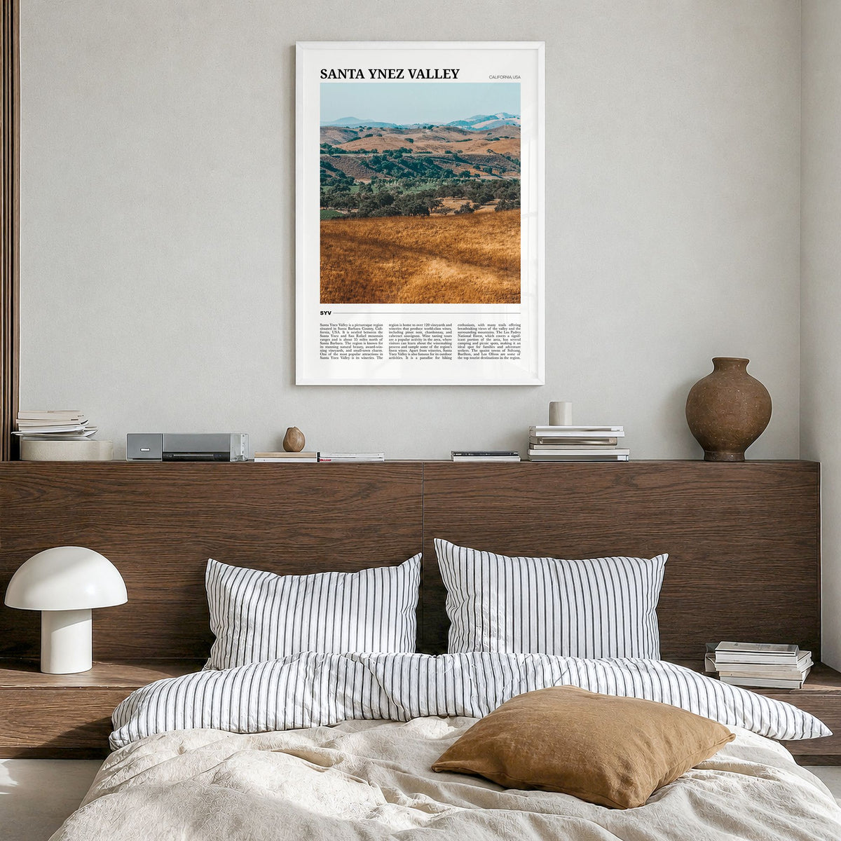 Santa Ynez Valley Travel Poster in a white wood frame, hanging in a bedroom